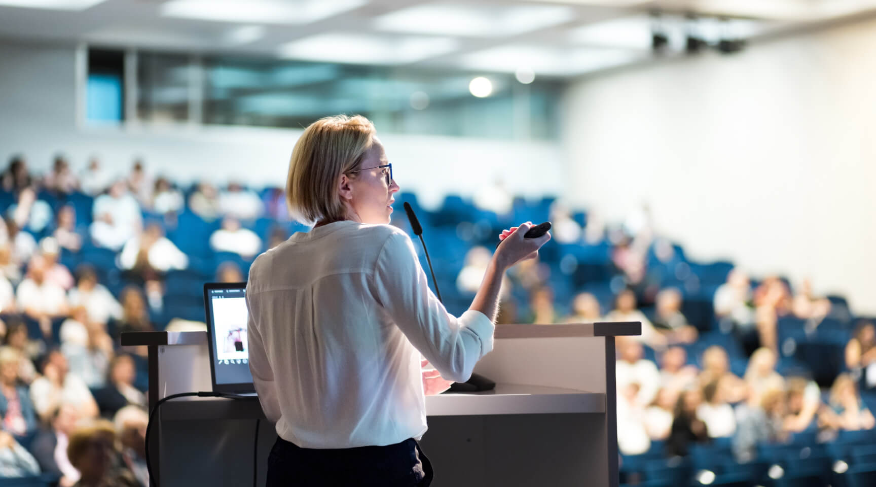 Speaker giving presentation in a lecture hall